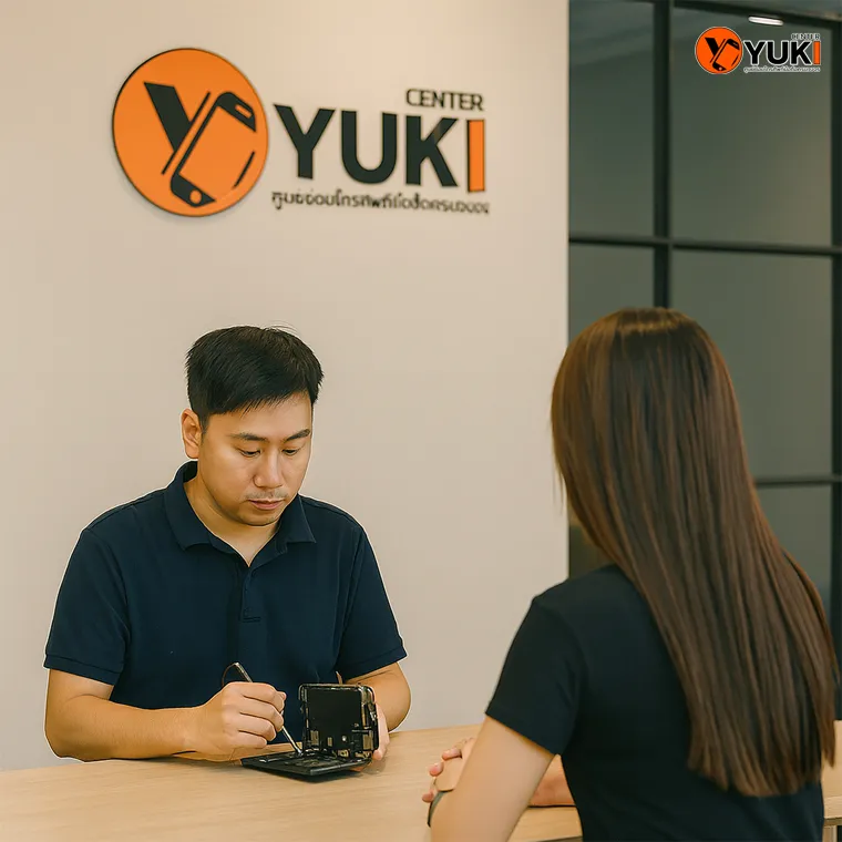 ทีมช่าง Yuki Center กำลังซ่อม iPhone ให้ลูกค้าในร้าน บริการซ่อมมือถือ ซ่อม iPhone และ iPad มืออาชีพ พร้อมโลโก้ร้าน