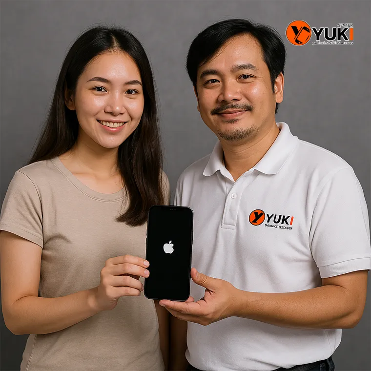 ภาพลูกค้ารับเครื่อง iPhone หลังซ่อมเสร็จจาก Yuki Center โดยมีช่างผู้เชี่ยวชาญส่งมอบเครื่องที่เปิดติดแล้วอย่างสมบูรณ์