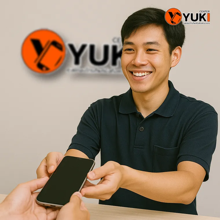 ช่างซ่อมมือถือยื่นเครื่องคืนลูกค้าด้วยรอยยิ้ม ที่ร้าน Yuki Center ศูนย์ซ่อมมือถือครบวงจรในกรุงเทพ