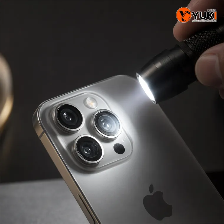 ใช้ไฟฉายตรวจสอบ iPhone กล้องหลังเป็นฝ้า โดยส่องเลนส์กล้องเพื่อเช็กความชื้น ไอน้ำ และคราบภายในโมดูลกล้องก่อนส่งซ่อม
